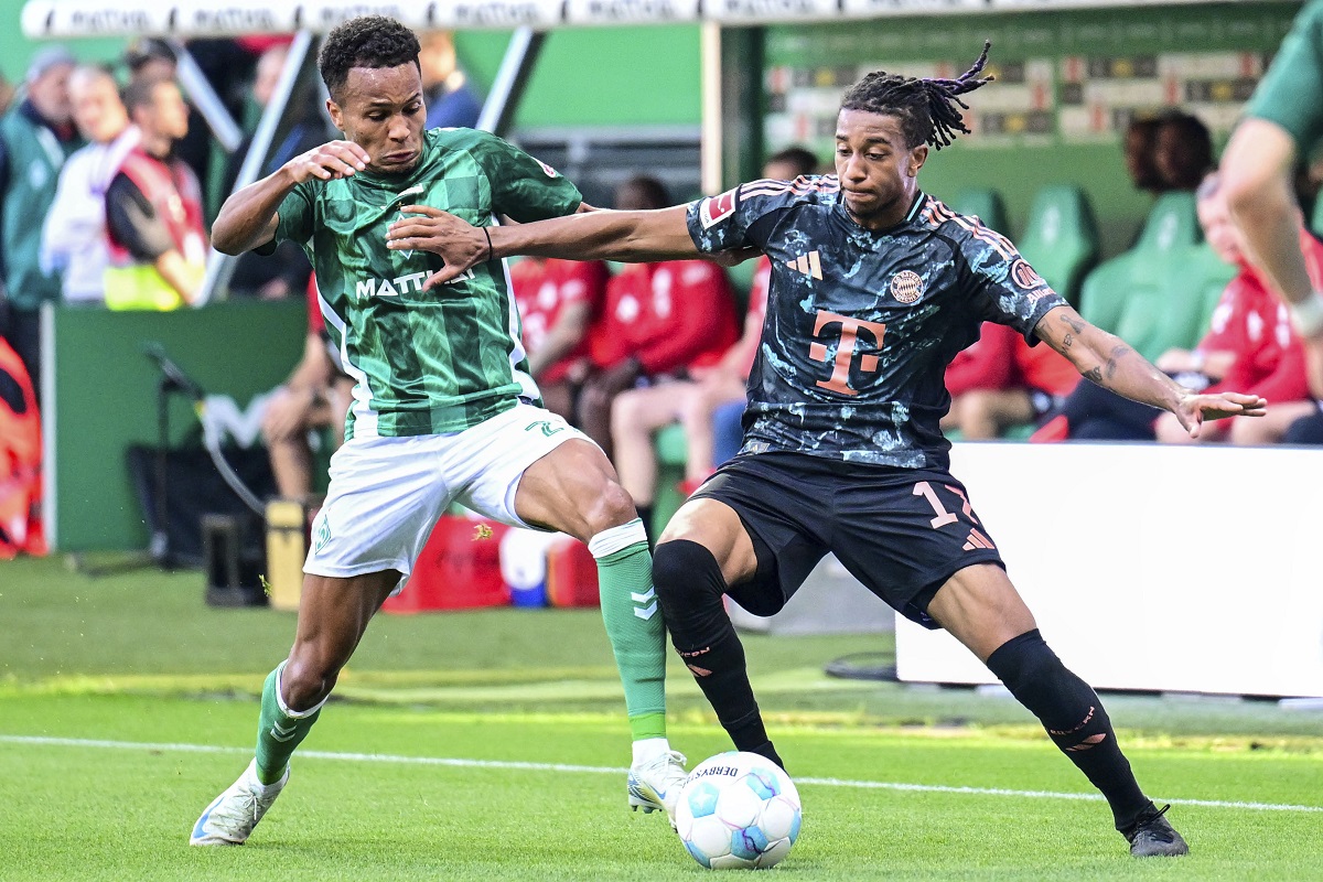 Werder's Felix Agu, left, and Bayern's Michael Olise, right, challenge for the ball during the German Bundesliga soccer match between SV Werder Bremen and Bayern Munich in Bremen, Germany, Saturday, Sept. 21, 2024. (Sina Schuldt/dpa via AP)