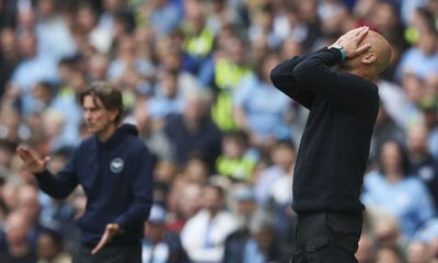 Manchester City's head coach Pep Guardiola, right, and Brentford's head coach Thomas Frank react during the English Premier League soccer match between Manchester City and Brentford at the Etihad Stadium in Manchester, England, Saturday, Sept. 14, 2024. (AP Photo/Scott Heppel)