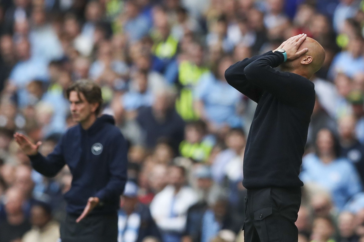 Manchester City's head coach Pep Guardiola, right, and Brentford's head coach Thomas Frank react during the English Premier League soccer match between Manchester City and Brentford at the Etihad Stadium in Manchester, England, Saturday, Sept. 14, 2024. (AP Photo/Scott Heppel)