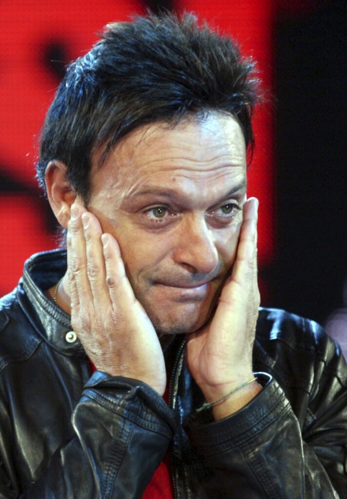 FILE- Former Italian striker Salvatore "Totò" Schillaci is overcome by emotion as he arrives at the reality show "L'Isola dei Famosi" in Milan, Italy, Friday, Nov. 19, 2004. (AP Photo/Antonio Calanni, file)