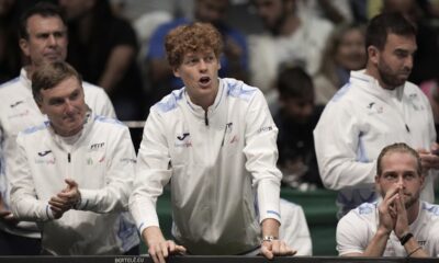 Italy's Jannick Sinner, center, shouts indications to Italy's Matteo Berrettini during a men's singles tennis Davis Cup tennis match between Berrettini and Botic Van Zandschulp of the Netherlands, at the Unipol arena, in Bologna, Italy, Sunday, Sept. 15, 2024. (Michele Nucci/LaPresse via AP)