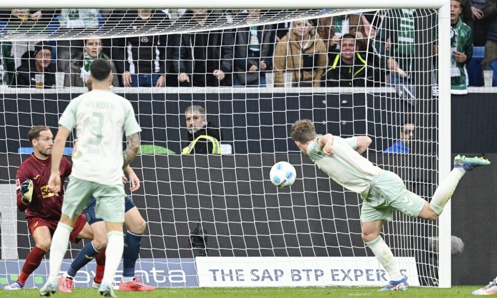 Bremen's Jens Stage, right, scores his side's fourth goal during the Bundesliga soccer match between TSG 1899 Hoffenheim and Werder Bremen, at the PreZero Arena in Sinsheim, Germany, Sunday, Sept. 29, 2024. (Uwe Anspach/dpa via AP)