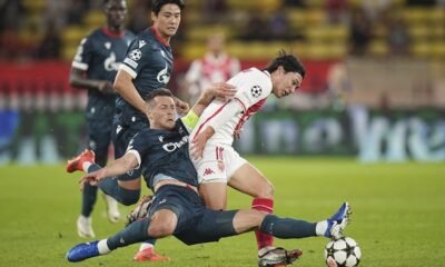 Monaco's Takumi Minamino, right, and Red Star's Uros Spajic fight for the ball during the Champions League opening phase soccer match between Monaco and Crvena Zvezda, Red Star Belgrade, at the Louis II stadium, in Monaco, Tuesday, Oct. 22, 2024. (AP Photo/Laurent Cipriani)