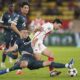 Monaco's Takumi Minamino, right, and Red Star's Uros Spajic fight for the ball during the Champions League opening phase soccer match between Monaco and Crvena Zvezda, Red Star Belgrade, at the Louis II stadium, in Monaco, Tuesday, Oct. 22, 2024. (AP Photo/Laurent Cipriani)