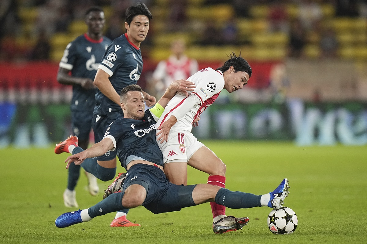 Monaco's Takumi Minamino, right, and Red Star's Uros Spajic fight for the ball during the Champions League opening phase soccer match between Monaco and Crvena Zvezda, Red Star Belgrade, at the Louis II stadium, in Monaco, Tuesday, Oct. 22, 2024. (AP Photo/Laurent Cipriani)