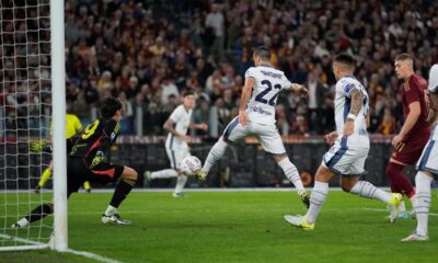 Roma's goalkeeper Mile Svilar, left, saves a shot by Inter Milan's Henrikh Mkhitaryan, centre, during the Serie A soccer match between Roma and Inter Milan at the Stadio Olimpico in Rome, Italy, Sunday, Oct. 20, 2024. (AP Photo/Andrew Medichini)