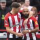 Brentford's Bryan Mbeumo, right, celebrates scoring his side's third goal of the game, during the English Premier League soccer match between Brentford and Ipswich Town, at the Gtech Community Stadium, in London, Saturday, Oct. 26, 2024. (John Walton/PA via AP)