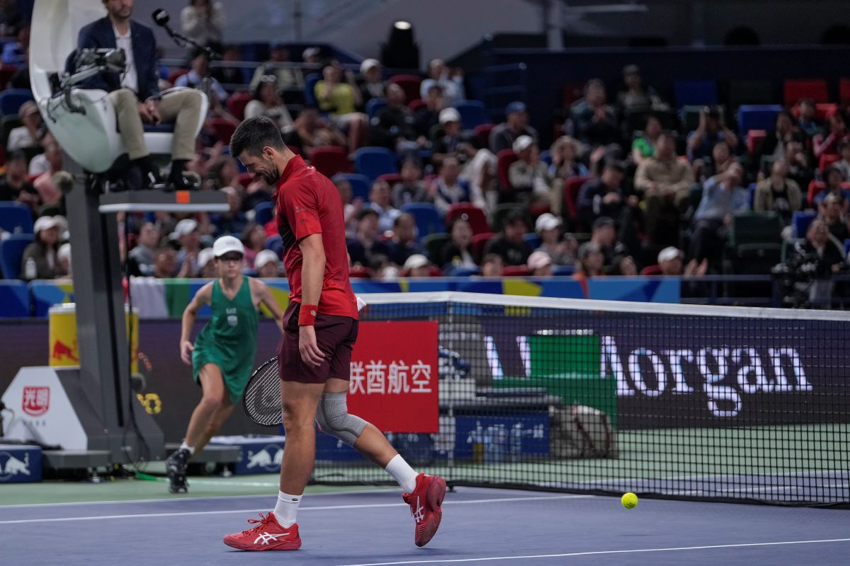 Novak Djokovic of Serbia reacts after failing to return a drop shot from Jannik Sinner of Italy during the men's singles match in the Shanghai Masters tennis tournament at Qizhong Forest Sports City Tennis Center in Shanghai, China, Sunday, Oct. 13, 2024. (AP Photo/Andy Wong)