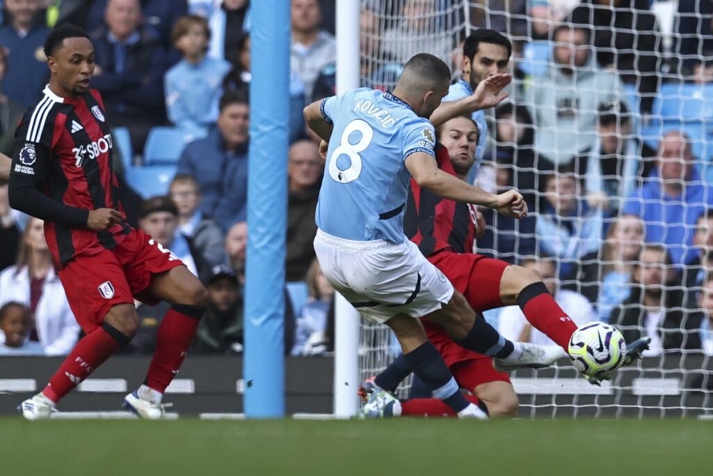 Manchester City's Mateo Kovacic, center, scores his side's second goal during the English Premier League soccer match between Manchester City and Fulham at Etihad Stadium in Manchester, England, Saturday, Oct. 5, 2023. (AP Photo/Darren Staples)