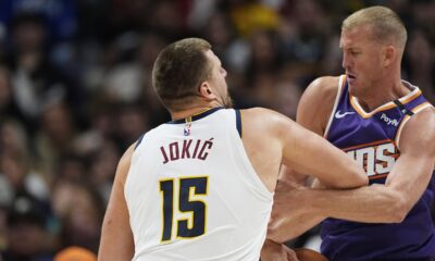 Phoenix Suns forward Mason Plumlee, right, steals the ball from Denver Nuggets center Nikola Jokic as he drives the lane in the second half of an NBA preseason game Sunday, Oct. 13, 2024, in Denver. (AP Photo/David Zalubowski)