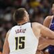 Phoenix Suns forward Mason Plumlee, right, steals the ball from Denver Nuggets center Nikola Jokic as he drives the lane in the second half of an NBA preseason game Sunday, Oct. 13, 2024, in Denver. (AP Photo/David Zalubowski)