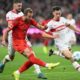 Munich's Harry Kane, left, plays against Stuttgart's Jeff Chabot during a German Bundesliga soccer match between FC Bayern Munich and VfB Stuttgart, in Munich, Germany, Saturday, Oct. 19, 2024. (Sven Hoppe/dpa via AP)