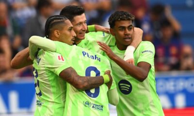 Barcelona's Robert Lewandowski, center, celebrates after scoring his side's 2nd goal against Alaves during a Spanish La Liga soccer match at the Mendizorroza stadium in Vitoria-Gasteiz, Spain, Sunday, Oct. 6, 2024. (AP Photo/Miguel Oses)