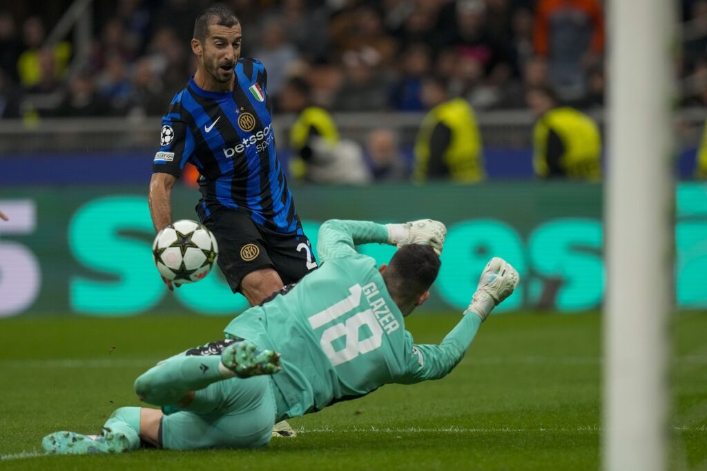 Red Star's goalkeeper Omri Glazer, front, makes a save in front of Inter Milan's Henrikh Mkhitaryan during the Champions League opening phase soccer match between Inter Milan and Red Star, at the San Siro stadium in Milan, Italy, Tuesday, Oct. 1, 2024. (AP Photo/Luca Bruno)