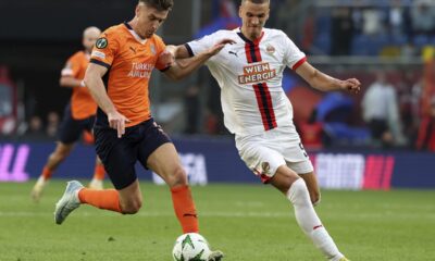 Rapid Wien's Nenad Cvetkovic, right, and Basaksehir's Krzysztof Piatek, fight for the ball during the Europa Conference League opening phase soccer match between Basaksehir and SK Rapid Wien at the Basaksehir Fatih Terim stadium in Istanbul, Turkey, Wednesday, Oct. 2, 2024. (Serkan Hacioglu/Dia Photo via AP)