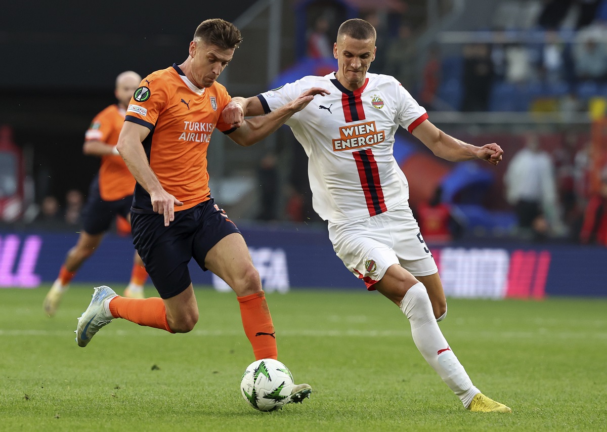 Rapid Wien's Nenad Cvetkovic, right, and Basaksehir's Krzysztof Piatek, fight for the ball during the Europa Conference League opening phase soccer match between Basaksehir and SK Rapid Wien at the Basaksehir Fatih Terim stadium in Istanbul, Turkey, Wednesday, Oct. 2, 2024. (Serkan Hacioglu/Dia Photo via AP)