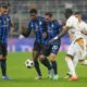 Inter Milan's Hakan Calhanoglu, second right, duels for the ball with Red Star's Cherif Ndiaye, right, during the Champions League opening phase soccer match between Inter Milan and Red Star, at the San Siro stadium in Milan, Italy, Tuesday, Oct. 1, 2024. (AP Photo/Luca Bruno)