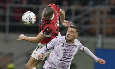 AC Milan's Strahinja Pavlovic, left, and Udinese's Lorenzo Lucca challenge for the ball during the Serie A soccer match between AC Milan and Udinese at the San Siro Stadium, in Milan, Italy, Saturday, Oct. 19, 2024. (AP Photo/Antonio Calanni)