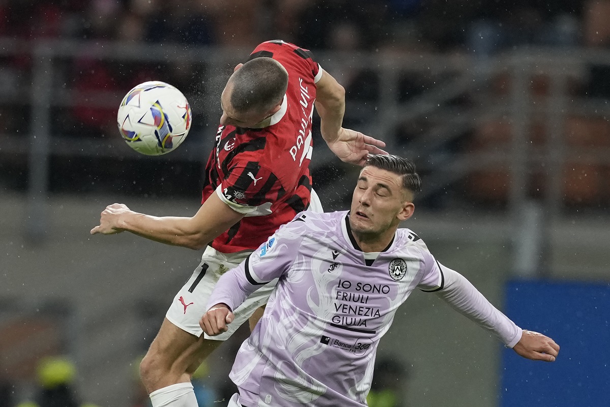 AC Milan's Strahinja Pavlovic, left, and Udinese's Lorenzo Lucca challenge for the ball during the Serie A soccer match between AC Milan and Udinese at the San Siro Stadium, in Milan, Italy, Saturday, Oct. 19, 2024. (AP Photo/Antonio Calanni)