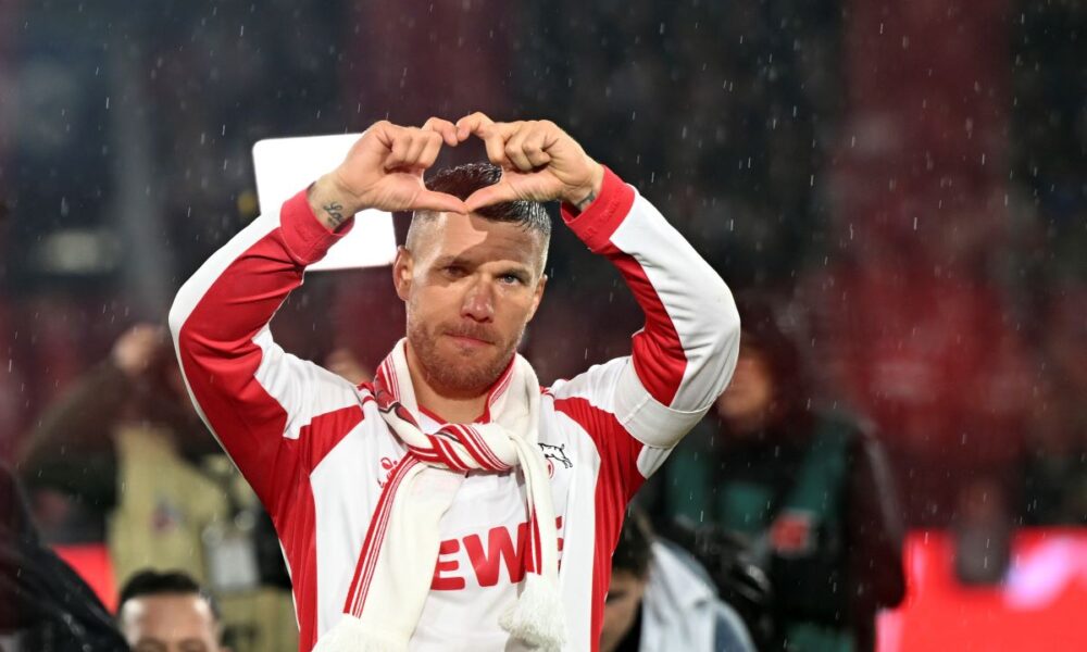 FC Köln's Lukas Podolski gestures to fans following his farewell soccer match, Thursday, Oct. 10, 2024, in Cologne, Germany. (Federico Gambarini/dpa via AP)