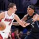 Miami Heat forward Nikola Jovic, left, drives up against Orlando Magic forward Paolo Banchero during the first half of an NBA basketball game, Wednesday, Oct. 23, 2024, in Miami. (AP Photo/Wilfredo Lee)