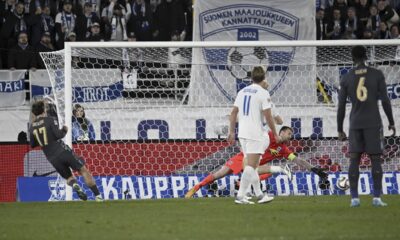 Jack Grealish of England, left, scores the opening goal past Finland's goalkeeper Lukas Hradecky during the UEFA Nations League soccer match between Finland and England, at the Olympic Stadium in Helsinki, Finland, Sunday, Oct. 13, 2024. (Markku Ulander/Lehtikuva via AP)