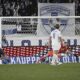 Jack Grealish of England, left, scores the opening goal past Finland's goalkeeper Lukas Hradecky during the UEFA Nations League soccer match between Finland and England, at the Olympic Stadium in Helsinki, Finland, Sunday, Oct. 13, 2024. (Markku Ulander/Lehtikuva via AP)