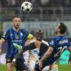 Inter Milan's Hakan Calhanoglu, right, duels for the ball with Red Star's Cherif Ndiaye, center, during the Champions League opening phase soccer match between Inter Milan and Red Star, at the San Siro stadium in Milan, Italy, Tuesday, Oct. 1, 2024. (AP Photo/Luca Bruno)