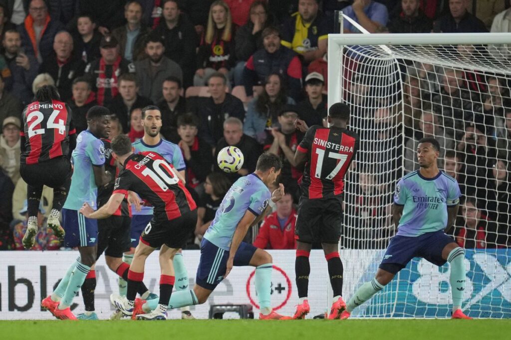 Bournemouth's Ryan Christie, centre, scores his side's opening goal during the English Premier League soccer match between Bournemouth and Arsenal at the Vitality Stadium in Bournemouth, England, Saturday, Oct. 19, 2024. (AP Photo/Kin Cheung)