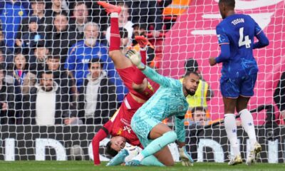 Liverpool's Curtis Jones, left, in action against Chelsea's goalkeeper Robert Sanchez during the English Premier League soccer match between Liverpool and Chelsea at Anfield Stadium, Liverpool, England, Sunday, Oct. 20, 2024. (AP Photo/Jon Super)