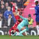 Liverpool's Curtis Jones, left, in action against Chelsea's goalkeeper Robert Sanchez during the English Premier League soccer match between Liverpool and Chelsea at Anfield Stadium, Liverpool, England, Sunday, Oct. 20, 2024. (AP Photo/Jon Super)