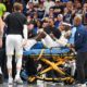 Utah Jazz forward Taylor Hendricks (0) is carried off by paramedics after sustaining an injury in the second half during an NBA basketball game against the Dallas Mavericks, Monday, Oct. 28, 2024, in Dallas. (AP Photo/Albert Pena)