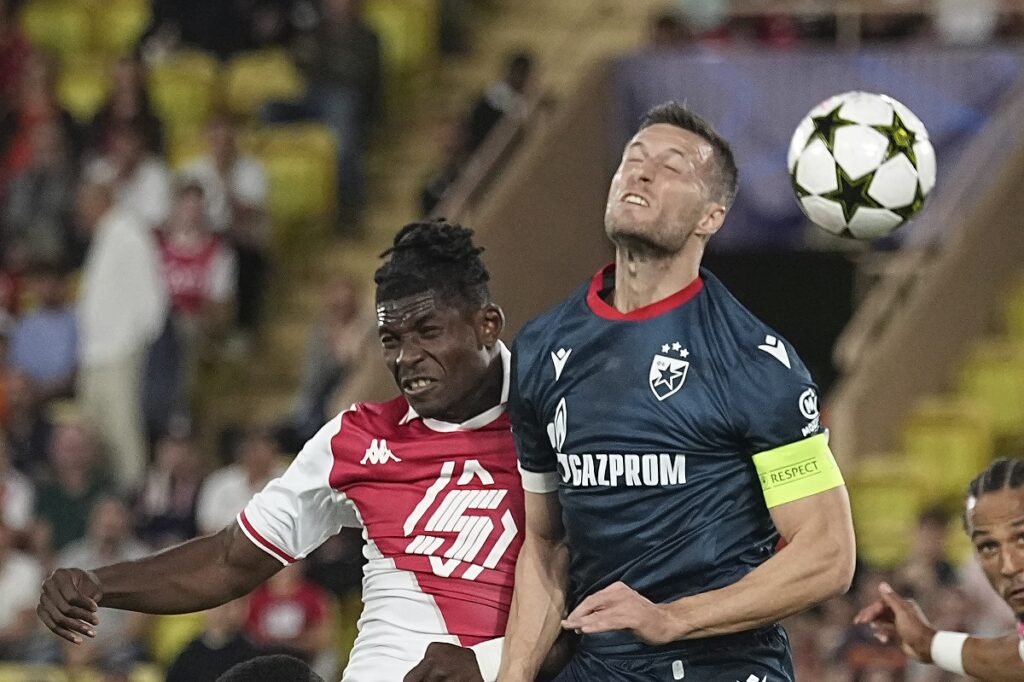 Monaco's Breel Embolo, left, and Red Star's Uros Spajic jump for the ball during the Champions League opening phase soccer match between Monaco and Crvena Zvezda, Red Star Belgrade, at the Louis II stadium, in Monaco, Tuesday, Oct. 22, 2024. (AP Photo/Laurent Cipriani)