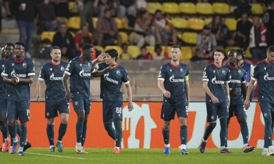 Red Star's players celebrate a goal from they teammate Cherif Ndiaye after scoring against Monaco during the Champions League opening phase soccer match between Monaco and Crvena Zvezda, Red Star Belgrade, at the Louis II stadium, in Monaco, Tuesday, Oct. 22, 2024. (AP Photo/Laurent Cipriani)