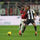 AC Milan's Rafael Leao, left, and Juventus' Khephren Thuram fight for the ball during the Serie A soccer match between AC Milan and Juventus at the San Siro stadium in Milan, Italy, Saturday, Nov. 23, 2024. (AP Photo/Antonio Calanni)