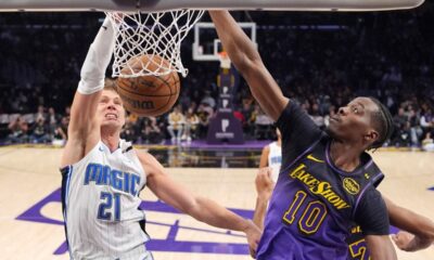 Orlando Magic center Moritz Wagner, left, dunks as Los Angeles Lakers center Christian Koloko defends during the first half of an NBA basketball game, Thursday, Nov. 21, 2024, in Los Angeles. (AP Photo/Mark J. Terrill)