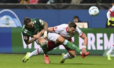 Werder's Marco Friedl, left, vies for the ball with Stuttgart's Ermedin Demirovic , during a German Bundesliga soccer match between Werder Bremen and VfB Stuttgart, in Bremen, Germany, Saturday, Nov. 30, 2024. (Carmen Jaspersen/dpa via AP)