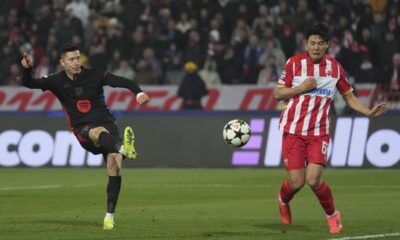 Barcelona's Robert Lewandowski shoots by Red Star's Seol Young-woo during the Champions League opening phase soccer match between Red Star and Barcelona at the Rajko Mitic Stadium in Belgrade, Serbia, Wednesday, Nov. 6, 2024. (AP Photo/Darko Vojinovic)