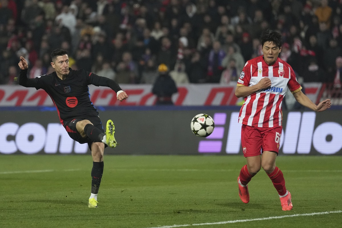 Barcelona's Robert Lewandowski shoots by Red Star's Seol Young-woo during the Champions League opening phase soccer match between Red Star and Barcelona at the Rajko Mitic Stadium in Belgrade, Serbia, Wednesday, Nov. 6, 2024. (AP Photo/Darko Vojinovic)