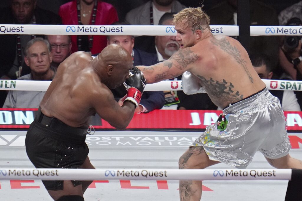 Mike Tyson, left, fights Jake Paul during their heavyweight boxing match, Friday, Nov. 15, 2024, in Arlington, Texas. (AP Photo/Julio Cortez)