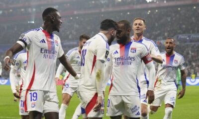 Lyon's Alexandre Lacazette, center right, celebrates with Lyon's Rayan Cherki after scoring a goal during the French League One soccer match between Lyon and Saint-Etienne at the Groupama stadium in Decines, outside Lyon, France, Sunday, Nov. 10, 2024. (AP Photo/Laurent Cipriani)