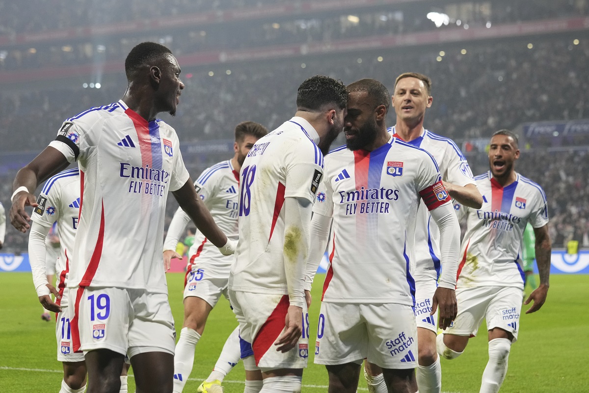 Lyon's Alexandre Lacazette, center right, celebrates with Lyon's Rayan Cherki after scoring a goal during the French League One soccer match between Lyon and Saint-Etienne at the Groupama stadium in Decines, outside Lyon, France, Sunday, Nov. 10, 2024. (AP Photo/Laurent Cipriani)