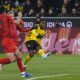 Dortmund's Jamie Gittens scores the opening goal during the German Bundesliga soccer match between Borussia Dortmund and Bayern Munich at the Signal-Iduna Park in Dortmund, Germany, Saturday, Nov. 30, 2024. (AP Photo/Martin Meissner)