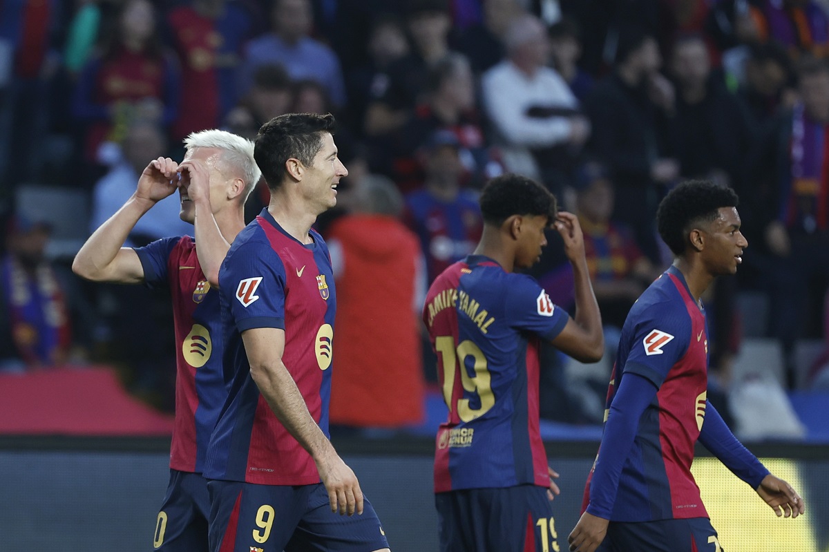 Barcelona's Dani Olmo, left, celebrates with Barcelona's Robert Lewandowski after scoring his side's opening goal during a Spanish La Liga soccer match between Barcelona and Espanyol at the Lluis Companys Olympic Stadium in Barcelona, Spain, Sunday, Nov. 3, 2024. (AP Photo/Joan Monfort)