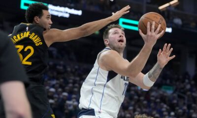 Dallas Mavericks guard Luka Doncic, right, shoots against Golden State Warriors forward Trayce Jackson-Davis during the first half of an Emirates NBA Cup basketball game in San Francisco, Tuesday, Nov. 12, 2024. (AP Photo/Jeff Chiu)