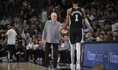 San Antonio Spurs head coach Gregg Popovich, left, greets Spurs forward Victor Wembanyama as he walks off of the court during the first half of an NBA basketball game against the Houston Rockets, Monday, Oct. 28, 2024, in San Antonio. (AP Photo/Darren Abate)