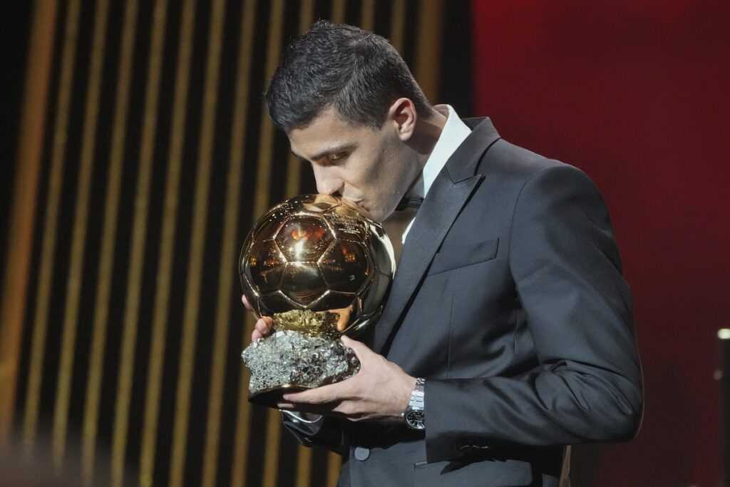 Manchester City's Spanish player Rodri kisses the trophy as he receives the 2024 Men's Ballon d'Or award during the 68th Ballon d'Or (Golden Ball) award ceremony at Theatre du Chatelet in Paris, Monday, Oct. 28, 2024. (AP Photo/Michel Euler)