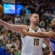 Denver Nuggets center Nikola Jokic (15) controls the ball as Utah Jazz forward Brice Sensabaugh (28) defends during the second half of an NBA basketball game Wednesday, Nov. 27, 2024, in Salt Lake City. (AP Photo/Rick Egan)