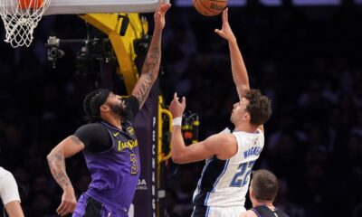 Orlando Magic forward Franz Wagner, right, shoots as Los Angeles Lakers forward Anthony Davis defends during the first half of an NBA basketball game, Thursday, Nov. 21, 2024, in Los Angeles. (AP Photo/Mark J. Terrill)