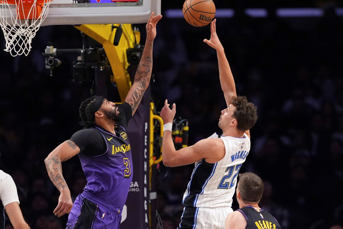 Orlando Magic forward Franz Wagner, right, shoots as Los Angeles Lakers forward Anthony Davis defends during the first half of an NBA basketball game, Thursday, Nov. 21, 2024, in Los Angeles. (AP Photo/Mark J. Terrill)